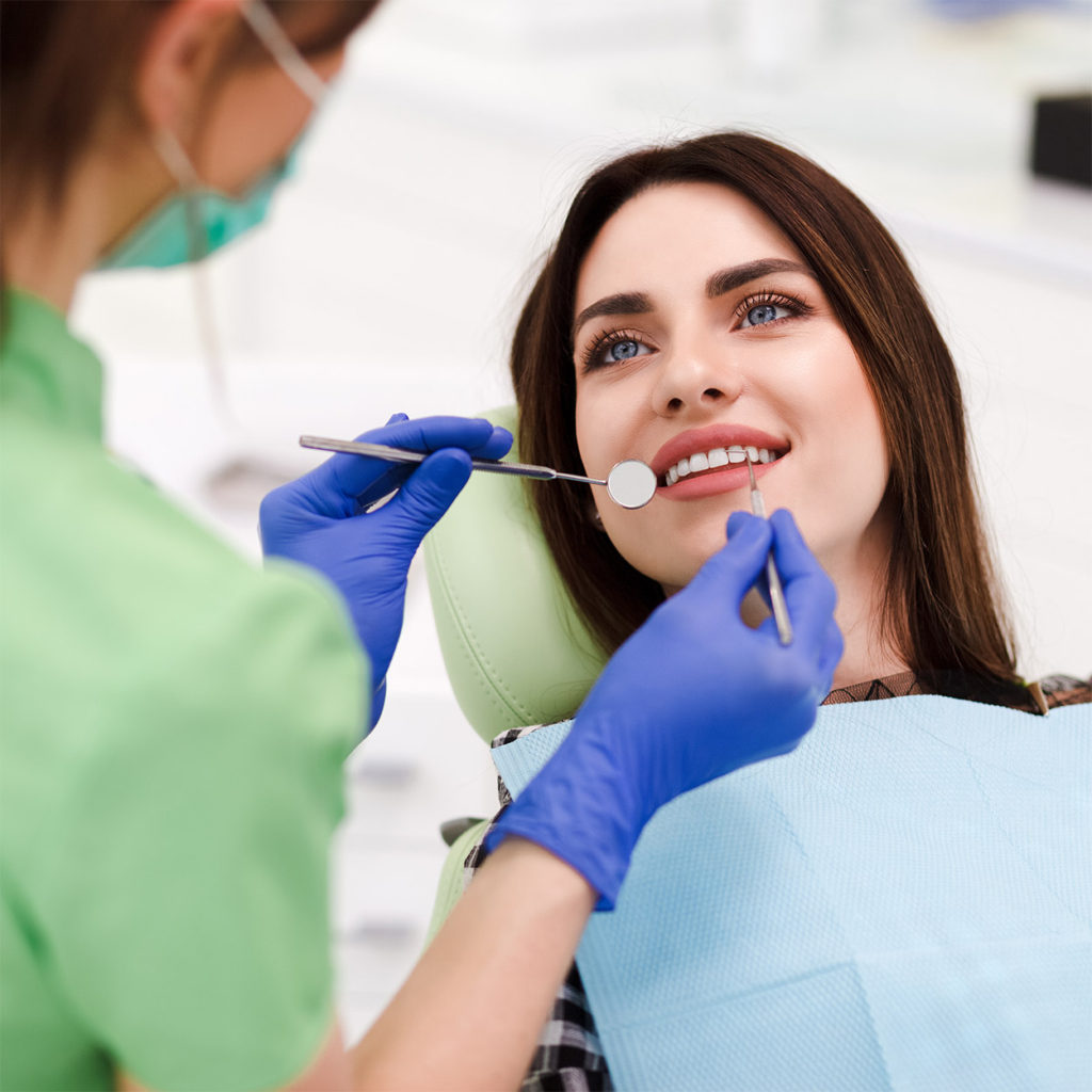 Beautiful young woman doing tooth examination in the dental office. Portrait of smiling girl on a dental chair in dentistry, sealant near me, dentis palos hills, lemont dentist