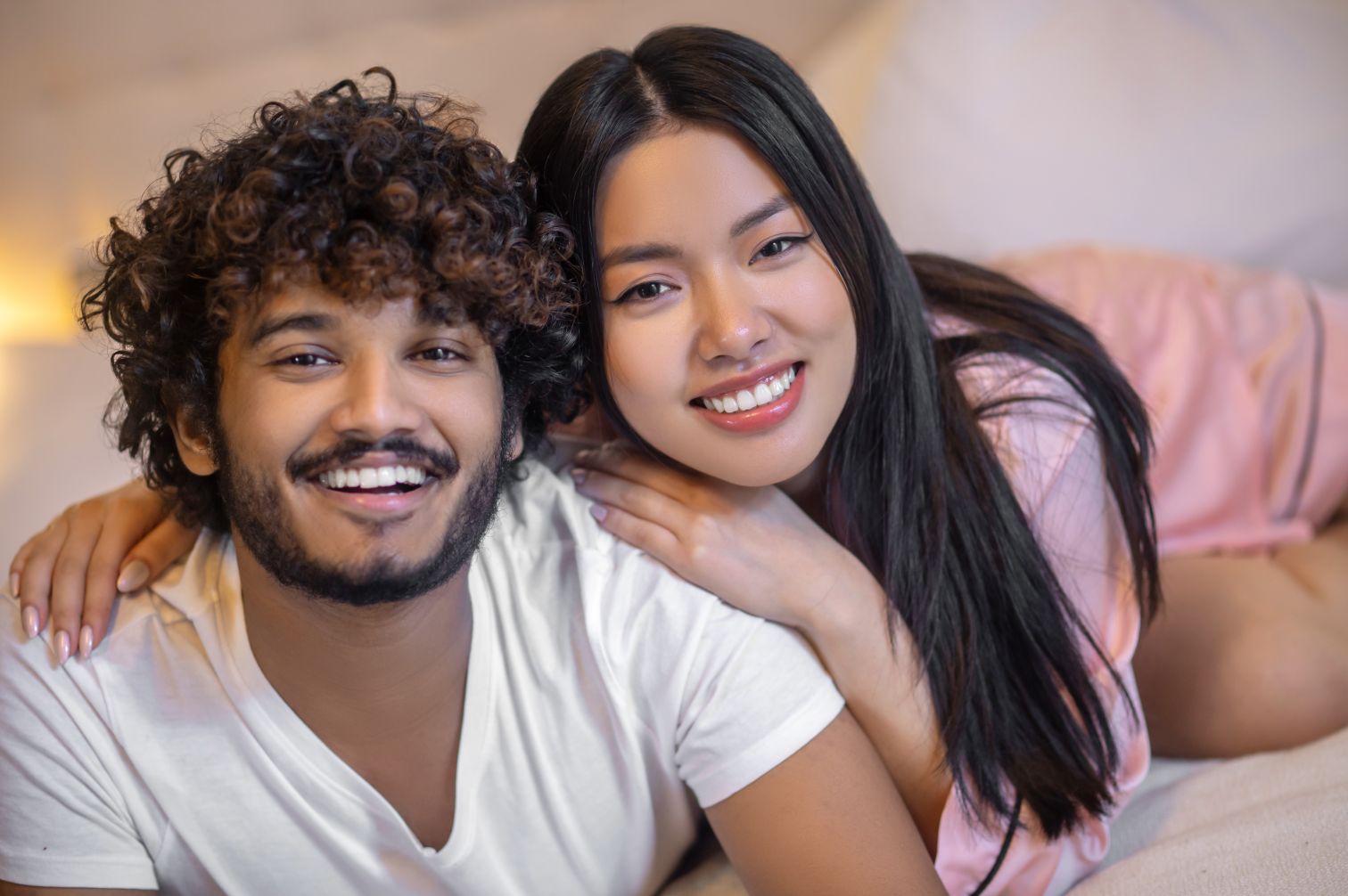 man and woman smiling with veneers