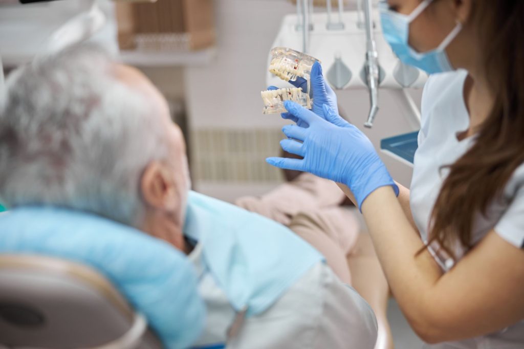 denture implants dental technician holding dentures