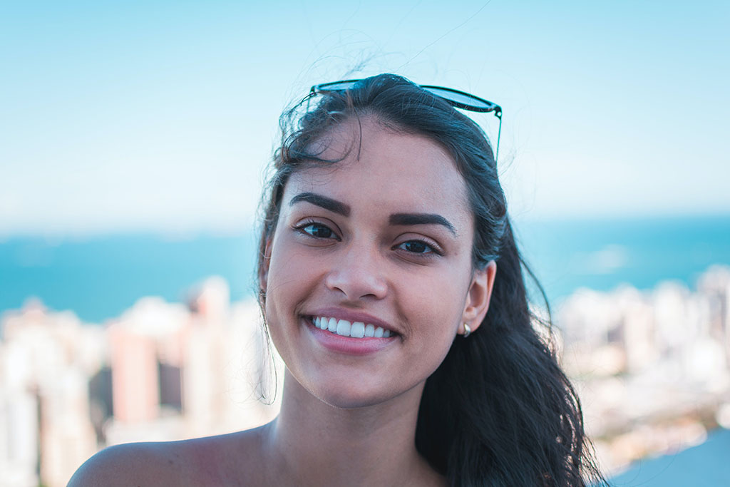 woman smiling with dental implant, veneers near me